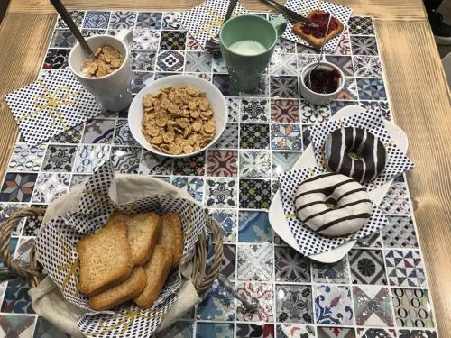 a table topped with different types of bread and pastries at B&B Geolja in Gioia Tauro