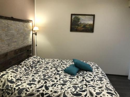 a bedroom with a bed with blue pillows on it at B&B Geolja in Gioia Tauro