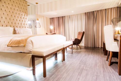 a hotel room with a bed and a desk at Grand Plaza Hotel Nampula in Nampula