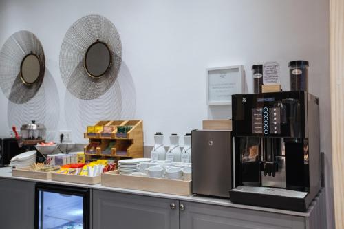 a kitchen with a counter with a coffee maker on it at Hotel Santa Cruz in Cangas de Onís