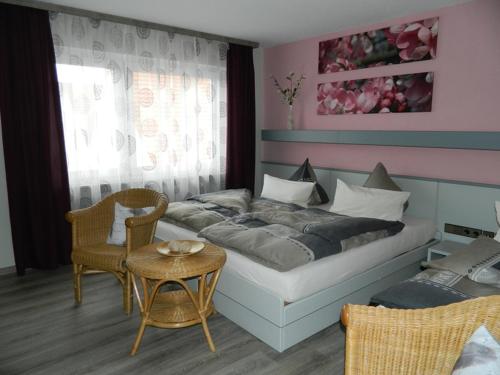 a bedroom with a bed and a table and chairs at Hotel Dietz in Bopfingen