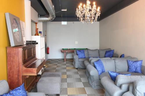 a living room with a couch and a piano at Hafnarstræti Hostel in Akureyri