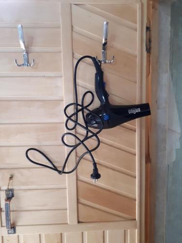 a black drone hanging from a wooden door at Fairy Tale in Gabala