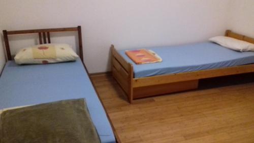 Habitación con 2 camas individuales y suelo de madera. en Apartment Green Valley, en Idrsko