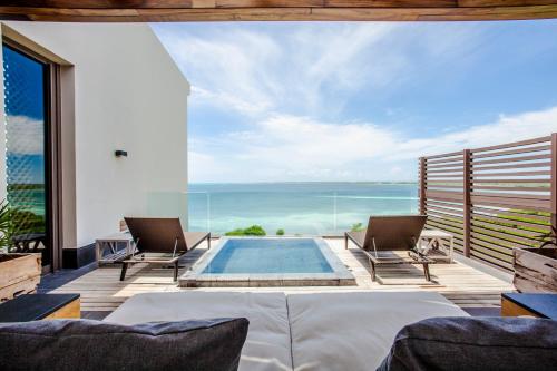 a villa with a pool and a view of the ocean at NIZUC Resort & Spa in Cancún