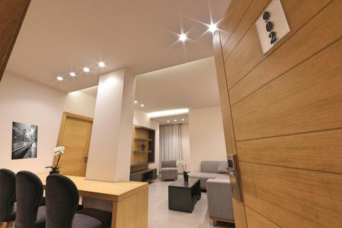 a room with a table and chairs and a living room at The Residence 649 in An Naqqāsh