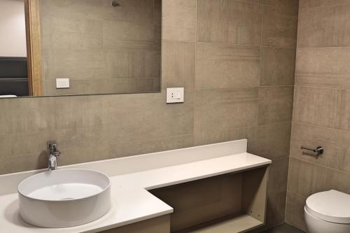 a bathroom with a sink and a toilet at The Residence 649 in An Naqqāsh