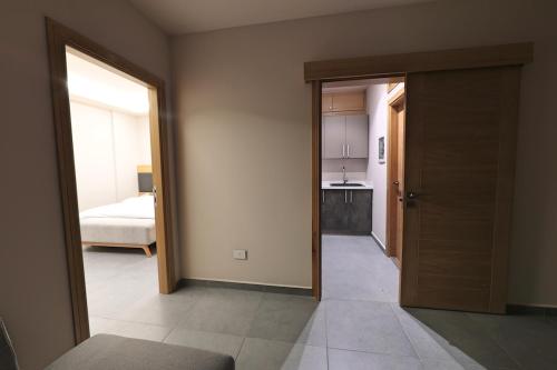 an empty room with a door leading to a bedroom at The Residence 649 in An Naqqāsh