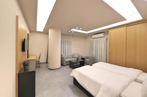 a bedroom with a bed and a living room at The Residence 649 in An Naqqāsh