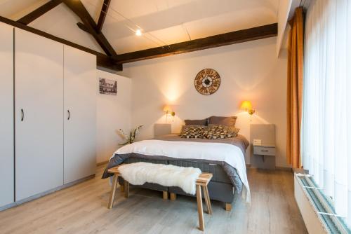 a bedroom with a bed and a large window at Inn Bruges in Bruges