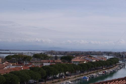 a city with a river and a bunch of boats at Residence Aprilia in Grado