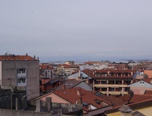 a view of a city with buildings and roofs at Residence Aprilia in Grado