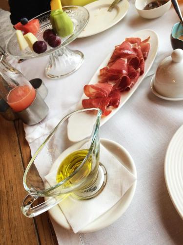 a table with a plate of food on a table at Puebloastur Eco Resort Hotel & Spa Gran Lujo in Cofiño