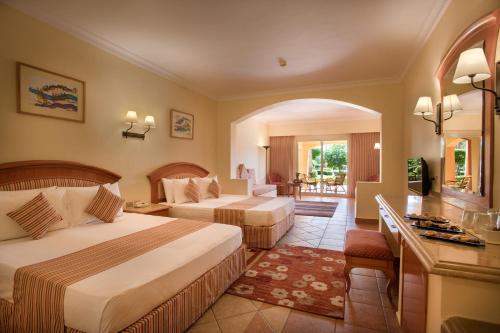 A bed or beds in a room at Sharm Grand Plaza Resort - Families and Couples Only