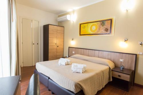 a bedroom with two beds with white towels on them at Lewisrooms Domo in Cagliari