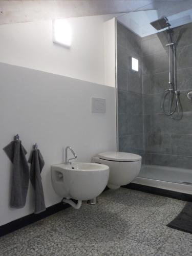 a bathroom with a toilet and a sink and a shower at Penthouse by the Sea in Levanto