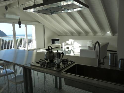 a kitchen with a sink and a stove top oven at Penthouse by the Sea in Levanto