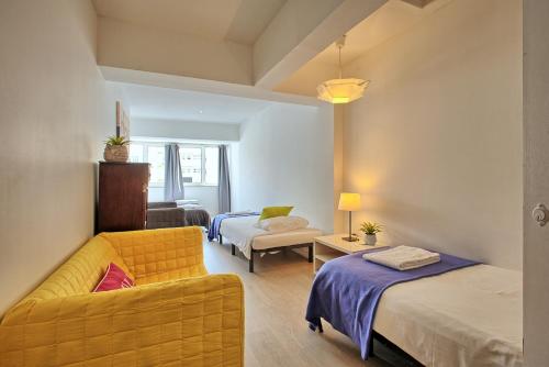 a living room with two beds and a couch at São Pedro 30 Guests Apartment in Lisbon