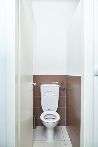 a bathroom with a white toilet in a stall at Lovecroatia Zagreb - 'Pax nest' in Zagreb