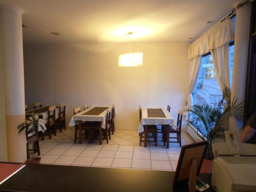 a dining room with tables and chairs and a window at Hotel Antartida Argentina in Ushuaia