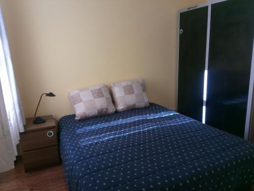 a bed with two pillows on it in a bedroom at Guesthouse Monsanto in Porto