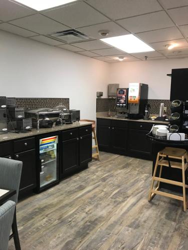 an empty room with black cabinets and a kitchen at Best Western Brookfield in Brookfield