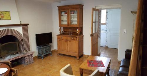 Le Petit Lustucru في Saint-Martin-des-Champs: غرفة معيشة مع تلفزيون ومدفأة