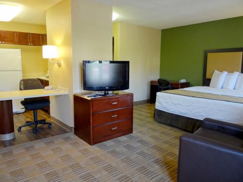 a hotel room with a bed and a flat screen tv at Extended Stay America Suites - Albuquerque - Rio Rancho Blvd in Rio Rancho