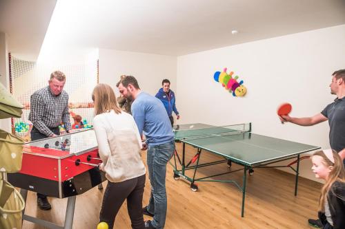 a group of people playing a game of ping pong at Hotel Le Alpi in Livigno