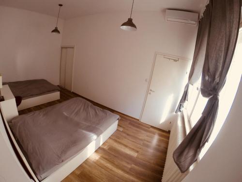 a small room with two beds and a window at Lovecroatia Zagreb - 'Pax nest' in Zagreb
