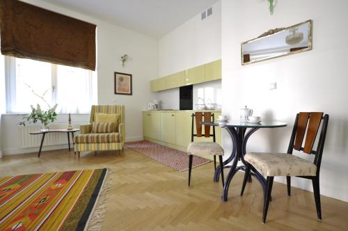 Il comprend une cuisine et un salon avec une table et des chaises. dans l'établissement Crystal Suites Old Town, à Cracovie