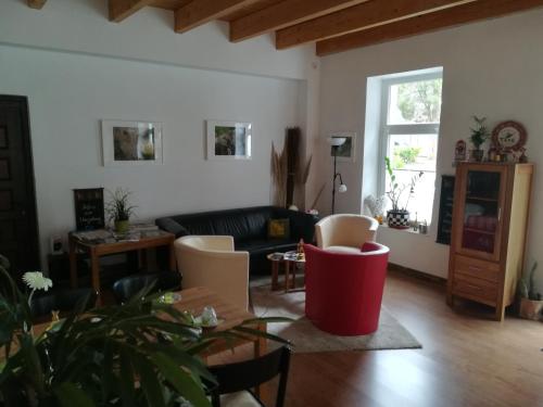 a living room with a couch and a table at Hotel Rutherbach in Essen