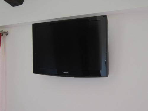 a flat screen tv hanging on a wall at B & B IL TRATTURO in San Pietro Avellana
