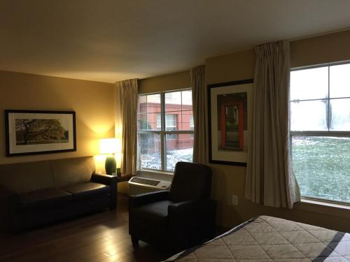 a bedroom with a bed and a chair and window at Extended Stay America Suites - Columbus - Polaris in Columbus