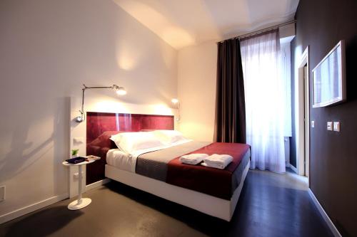 a hotel room with a bed and a window at Inn Urbe Colosseo in Rome