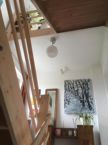 an attic room with a staircase and a painting on the wall at Atelierwohnung Jirana in Saalfelden am Steinernen Meer