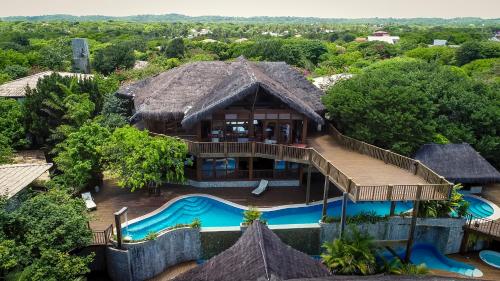 an aerial view of a resort with a swimming pool at Sombra e Água Fresca Floresta in Pipa