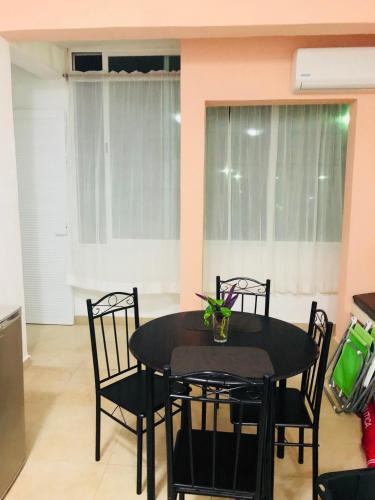 a dining room with a black table and chairs at Condo Mar Arena in Playa del Carmen