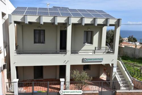 a house with solar panels on top of it at Green Point Home Chios in Vrontados