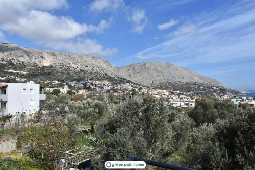 a view of a city with mountains in the background at Green Point Home Chios in Vrontados