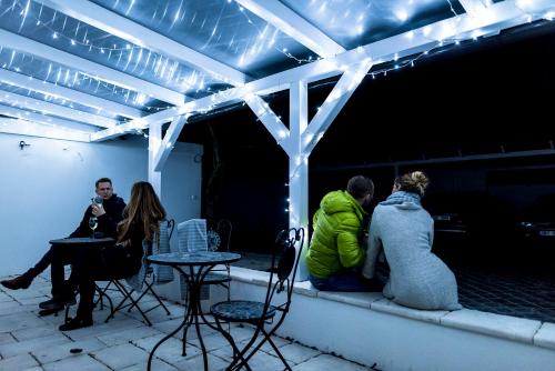 a group of people sitting on a patio at night at Penzion Pumpion in Valtice