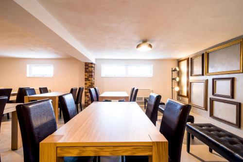 a conference room with wooden tables and chairs at Penzion Pumpion in Valtice