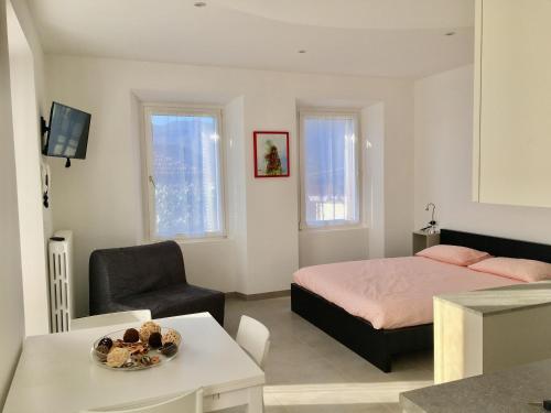 a bedroom with a bed and a chair and a table at Casa Cesira in Pettenasco