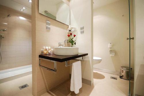 a bathroom with a sink and a toilet at Capsis Hotel Thessaloniki in Thessaloniki