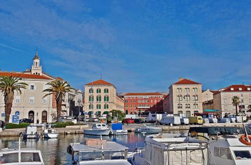 a group of boats docked in a harbor with buildings at Guest House Varos in Split