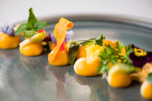 a plate of food with vegetables on a table at Résidence des Châteaux in Ottrott