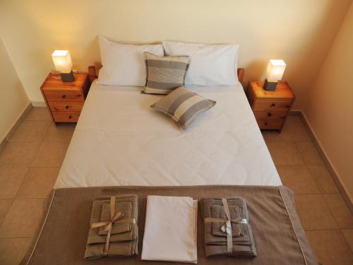 a bedroom with a large bed with two night stands at Maria-Villa in Psakoudia