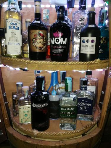 a shelf with many bottles of alcohol on it at Hotel Mondschein in Sesto
