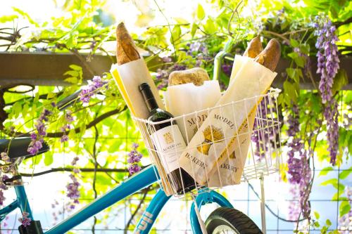 a basket on a bike with bread and wine at River Terrace Inn, a Noble House Hotel in Napa