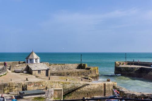 a view of a pier with the ocean behind it at Pier House in St Austell